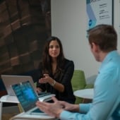 person talking to another while on a computer